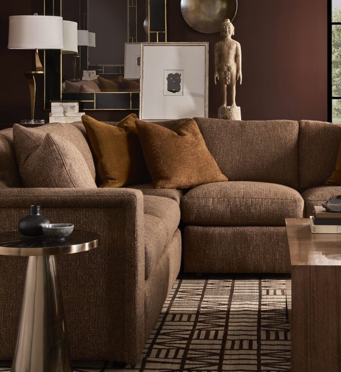 Warm chocolate curved sectional with rust accents, a Fall High Point Market look from Hickory White