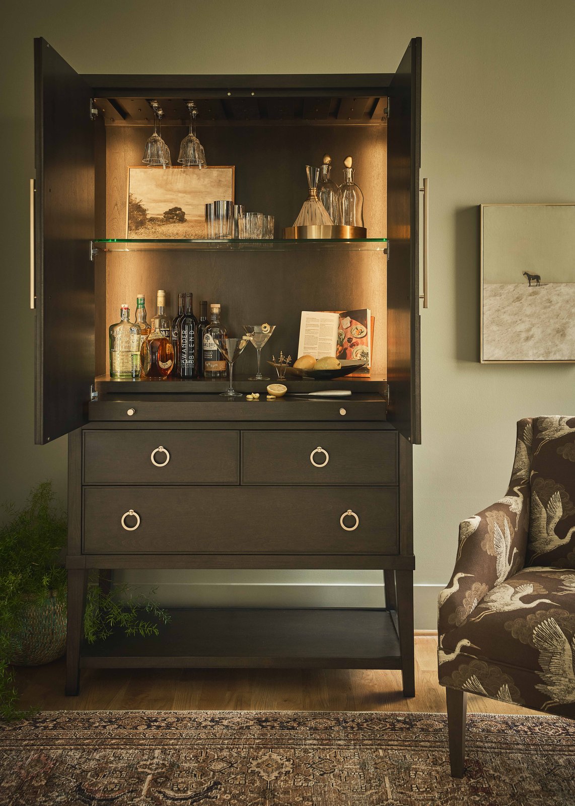Universal Furniture Fenwick Bar Cabinet with integrated lighting and glassware, open for cocktail hour