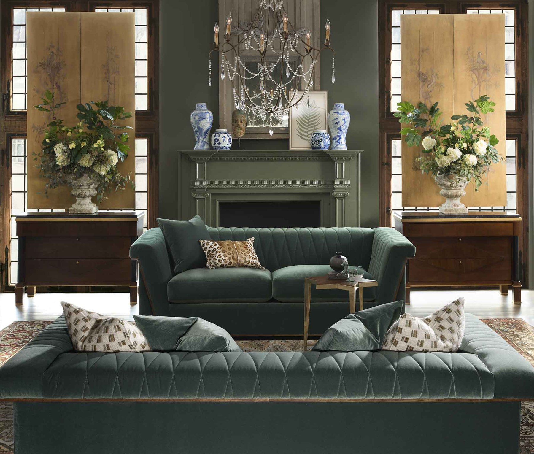Classic green tufted sofas styled fresh with blue-and-white porcelain, a new-traditional look from Hickory White