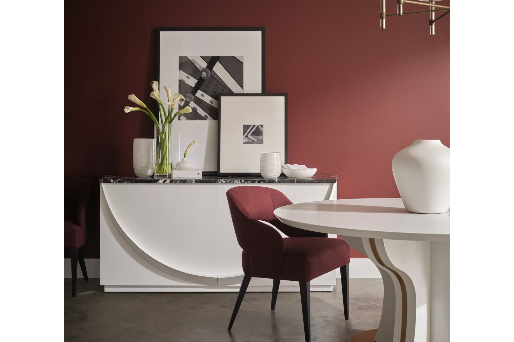 Dining room with a rich merlot wall and warm, layered palette from Baker