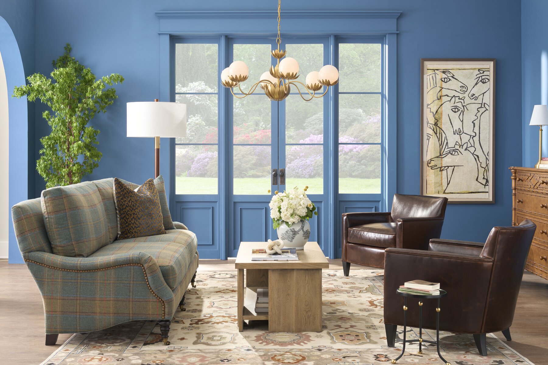 Wesley Hall Thomas Sofa in plaid, styled in a warm blue living room with leather chairs