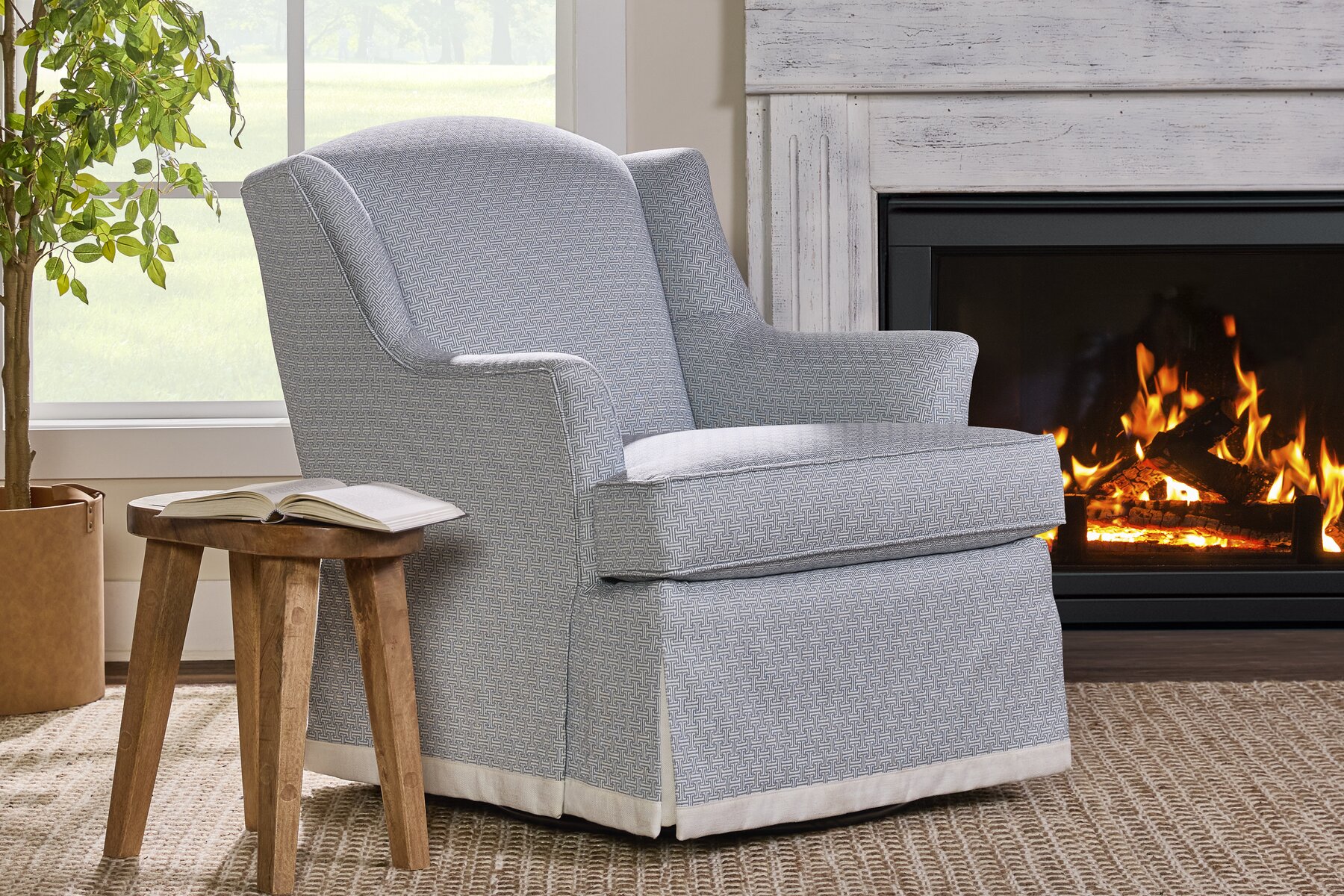 Wesley Hall Dawson Swivel Glider by a fireplace