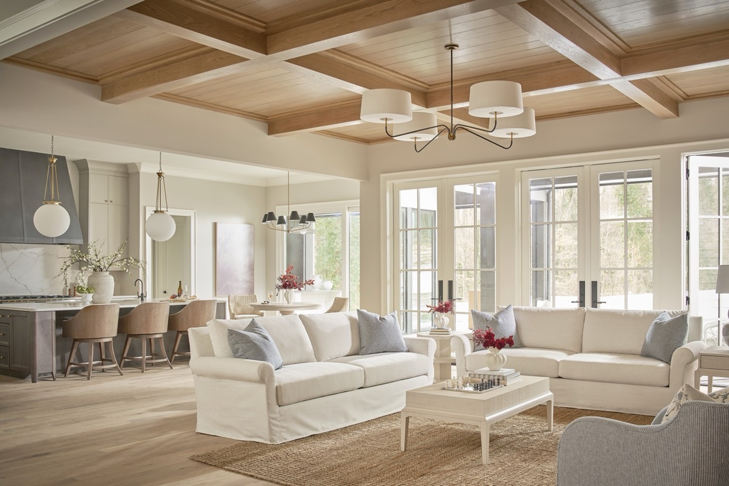 An open concept great room with the living, dining, and kitchen zones flowing together